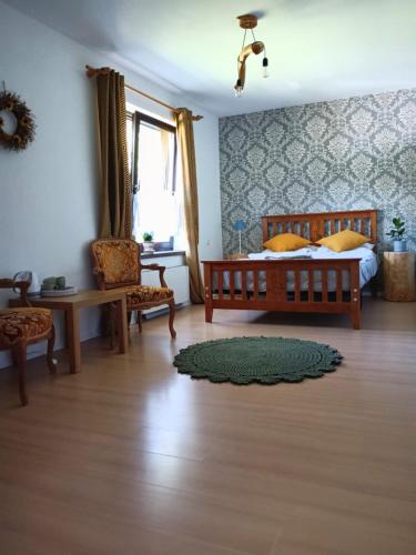 a bedroom with a bed and a table and chairs at Smrek Sokolec Agroturystyka in Ludwikowice Kłodzkie