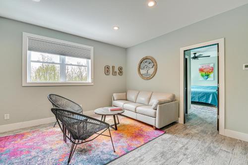 a living room with a couch and a chair at Fire Pit and Beach Access Quiet Northville Retreat in Benson