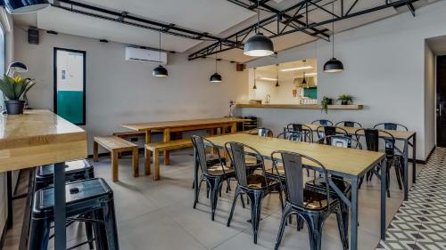 a dining room with wooden tables and chairs at Hostellicious in Faro