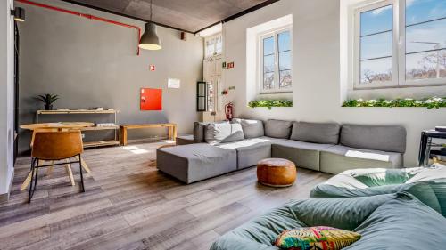 a living room with a couch and a table at Hostellicious in Faro
