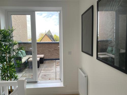 a room with a sliding glass door with a patio at Comfortable double room & single room in vibrant Hatfield neighbourhood in Hatfield