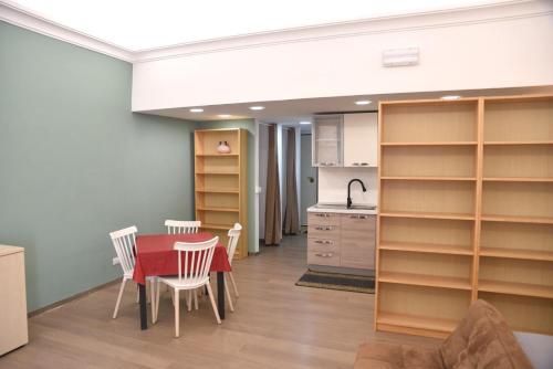 a kitchen and dining room with a table and chairs at Loft Atenea in Agrigento