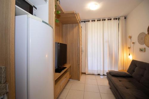 a small living room with a couch and a tv at OZPED Flats Particulares Edifício Life Resort in Brasilia