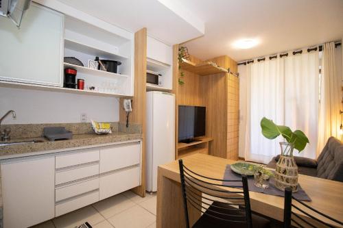 a kitchen and dining room with a table and a refrigerator at Hotel Life Resort Brasília - Ozped Flats in Brasilia