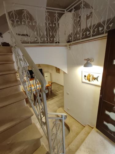 a staircase leading up to a living room with a table at B&B Punta Cutieri in Gallipoli