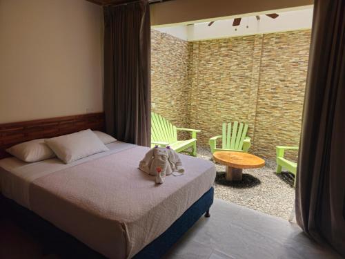 a stuffed animal sitting on a bed in a bedroom at Caribbean Sea Towers Hotel in Puerto Viejo