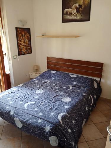 a bedroom with a bed with a blue comforter at Camere ANNA in Florence