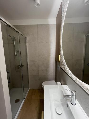 a bathroom with a sink and a shower and a toilet at Pokoje gościnne u Doroty in Kazimierz Dolny