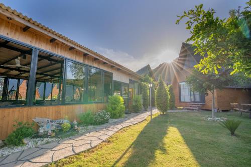 a house with a garden in front of it at Karaöz Sapphire Bungalows in Kumluca