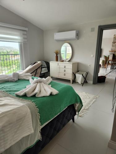 een slaapkamer met een bed met een spiegel en een raam bij White coral house in Dalaman