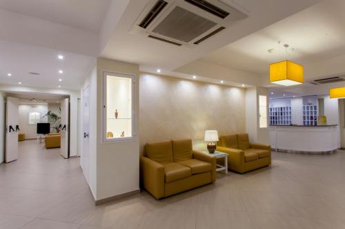 a lobby with two chairs and a waiting room at Hotel Costazzurra Museum & Spa in San Leone