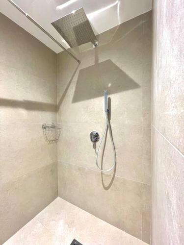 a shower with a shower head in a bathroom at Dimora dei lidi in Fontane Bianche
