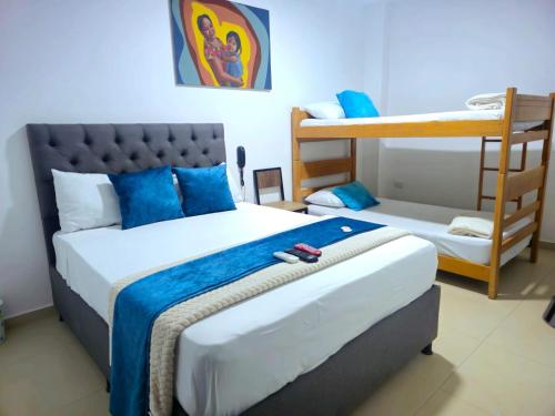 a bedroom with a bed and a bunk bed at ANAJIRAWAA HOTEL in Ríohacha
