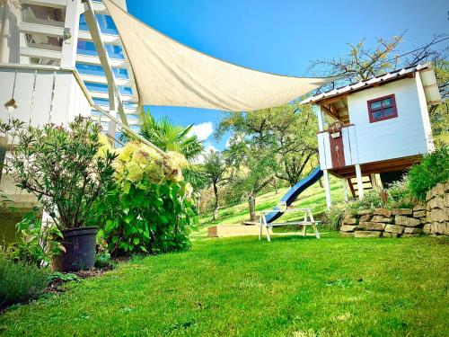 a house with a slide in a yard with a house at Ferienapartment Huber in Oberkirch