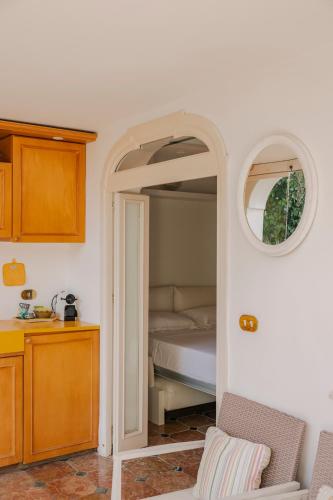 a bedroom with a bed with an open doorway at 23Baci, Capri in Capri