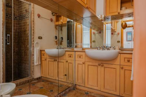 a bathroom with two sinks and a shower at 23Baci, Capri in Capri