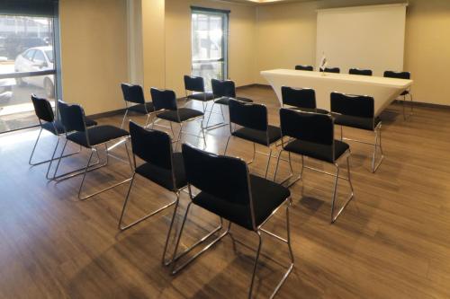 a conference room with chairs and a white table at City Express by Marriott Rosarito in Rosarito