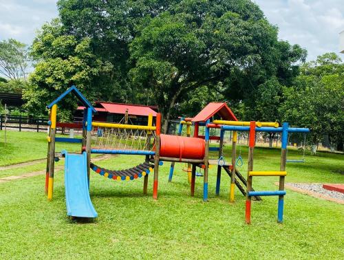 a playground with colorful equipment in a park at Finca El Descanso in Villavicencio