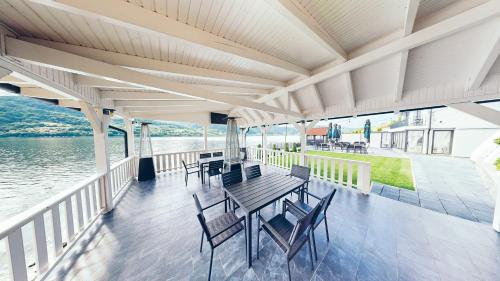 a deck with tables and chairs on a boat at Pensiunea Rodan in Orşova