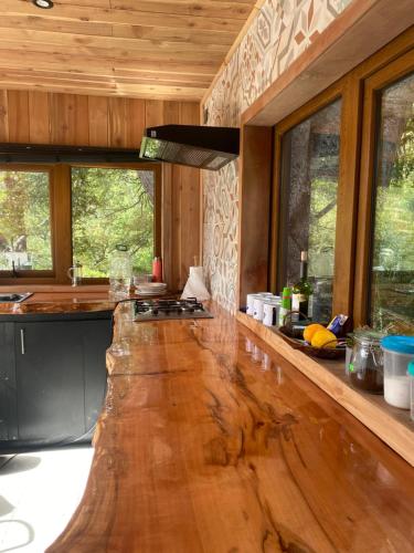 a kitchen with a large wooden counter top at Lodge Rincon del Bosque, Malalcahuello in Malalcahuello