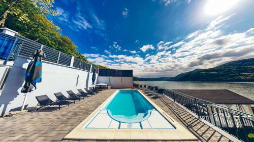 a swimming pool on the deck of a boat on the water at Pensiunea Rodan in Orşova