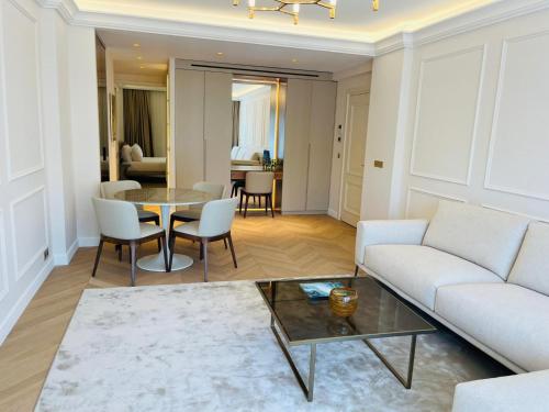 a living room with a couch and a table at xGP Track Flat, Up to 14 Guests in Monte Carlo