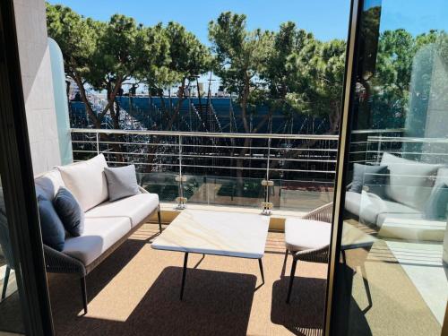 a living room with a couch and a table at xGP Track Flat, Up to 14 Guests in Monte Carlo