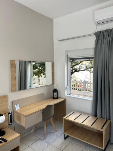 a room with a desk and a window at Stelios Studios Sougia in Sougia
