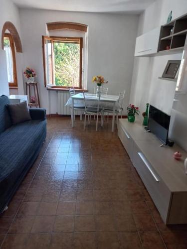 a living room with a couch and a table at Casa Ines - Borgo di Bibbona in Bibbona
