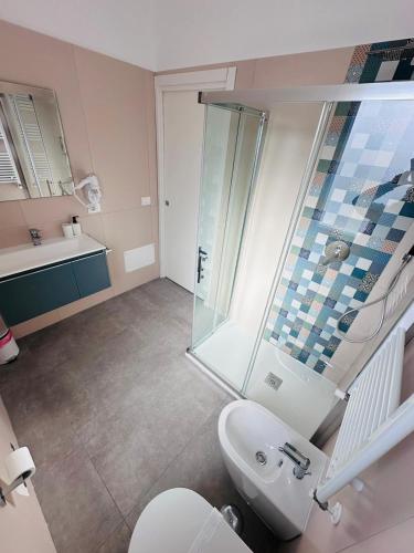 a bathroom with a shower and a toilet and a sink at B&B Raphaël in Marigliano