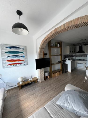 a living room with a bed and a living room with a kitchen at La Costera in Barrio-Mar