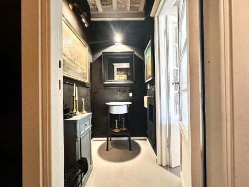 a bathroom with a sink and a black wall at Residenza dell'Orto - Residenze Tonnina Group in Guardistallo