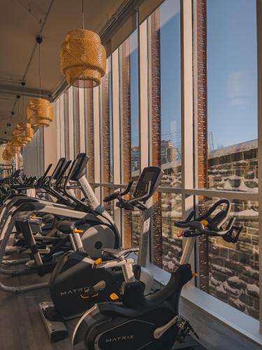 a row of exercise bikes in a fitness room at Le Capitole Hotel in Quebec City
