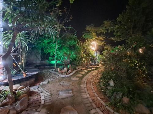 a garden at night with a fountain and trees at Bungalow HTC tuần châu in Ha Long