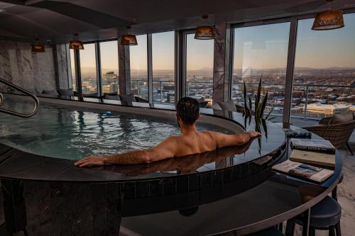 a man in a swimming pool at a hotel at Le Capitole Hotel in Quebec City