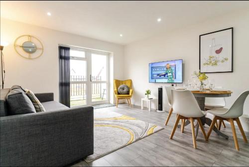 a living room with a couch and a table at Bridge Court by Sterling Edge Apartments - Luxury Aparthotel - Stylish 1-bed Apartments - Balcony with Canal View or Private Garden - Free Parking in Birmingham