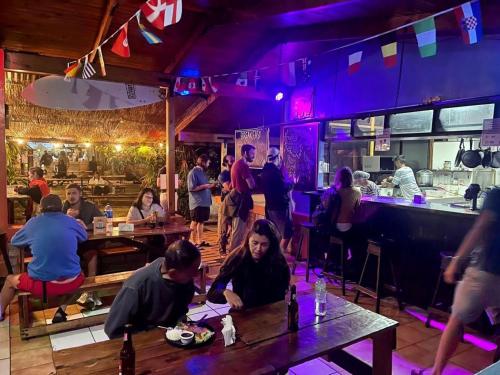 Costa Rica Guesthouse في سان خوسيه: مجموعة من الناس يجلسون على الطاولات في المطعم