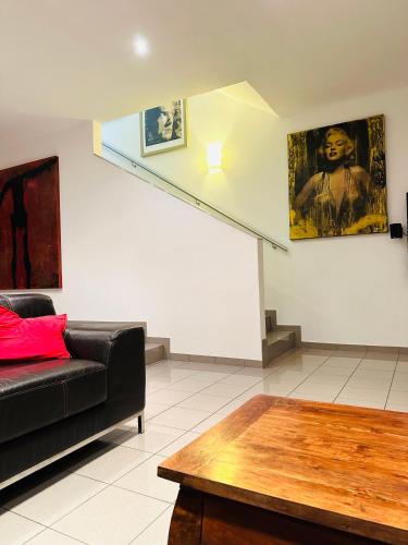 a living room with a black couch and a staircase at LUXURY STAY SALZBURG City in Salzburg