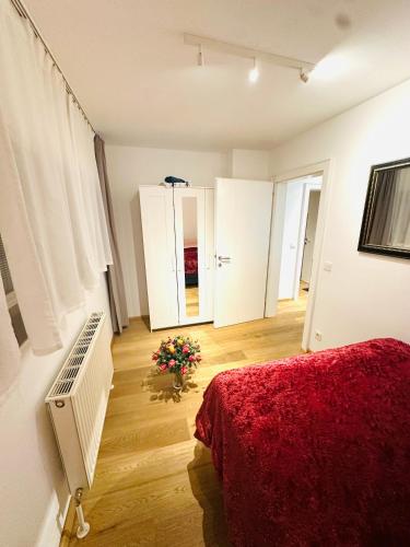 a white room with a bed and a red blanket at LUXURY STAY SALZBURG City in Salzburg
