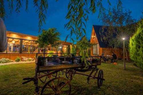 a wooden cart in the yard of a house at Karaöz Sapphire Bungalows in Kumluca