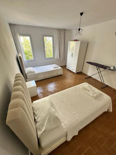 a room with two beds and a couch in it at Albedo Apartment in Kaş