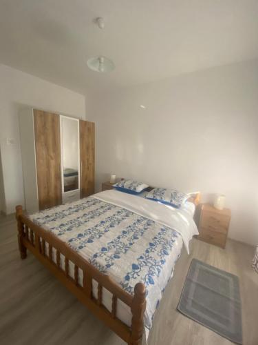 a bedroom with a bed with a blue and white comforter at Apartment Neno 2 in Senj