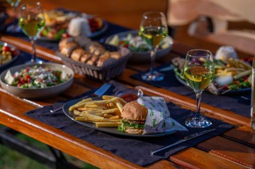 a table topped with plates of food and glasses of wine at Karaöz Sapphire Bungalows in Kumluca