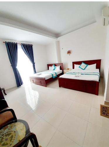 a bedroom with two beds and a window at HOTEL VIỆT ÚC, H17 Phan Huy Chú, phường Vũng Tàu in Vung Tau