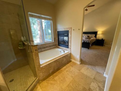 a bathroom with a bath tub and a window at Perfect Pike's peak basecamp & spacious luxury in Cascade-Chipita Park