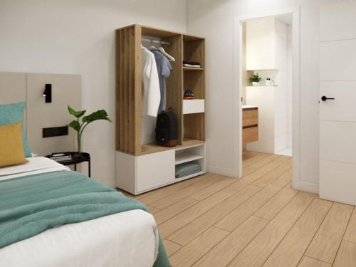 a bedroom with a bed and a closet with a dresser at Live santa cruz solarium in Santa Cruz de Tenerife