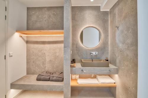 a bathroom with a sink and a mirror at Marinatou Suites in Antiparos Town