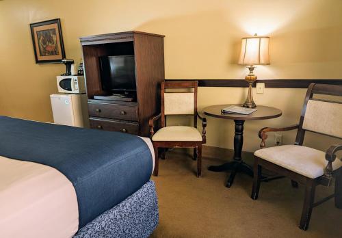 a hotel room with a bed and a table and chairs at First Gold Gaming Resort in Deadwood