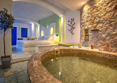 a bathroom with a large tub in a room at Astarte Suites in Akrotiri