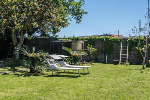 a garden with a bench in the grass at Agriturismo Giorgi appartamenti in Riviera Ligure in Albenga